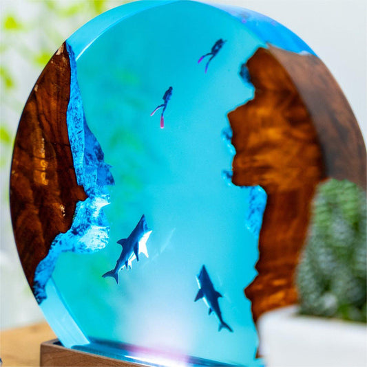 This scenic ocean landscape lamp that realistically depicts a shark and divers exploring a coral reef or shipwreck. This can be achieved through detailed sculpting, painting, or even 3D printing for a truly immersive experience.