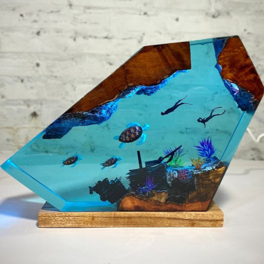 Capture the essence of the ocean with a lamp  and immerse in a shipwreck and a sea turtle, with soft colors and dreamlike quality.